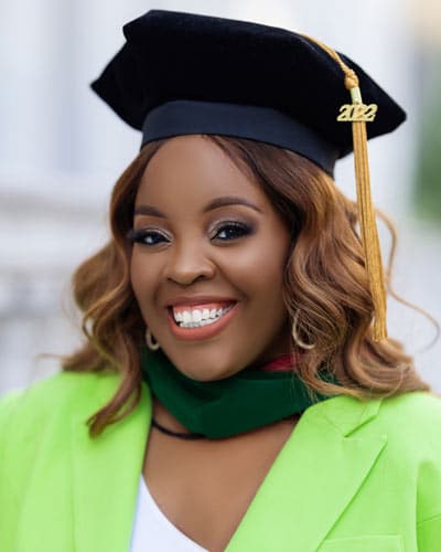 Person wearing a black graduation cap with "2022" on the tassel